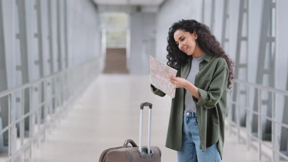 Young Caucasian Lady Girl Woman Female Passenger Tourist Traveler with Suitcase Stands at Airport