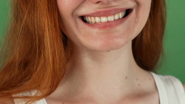 Red Haired Woman Smiling Happily on Green Chromakey Background