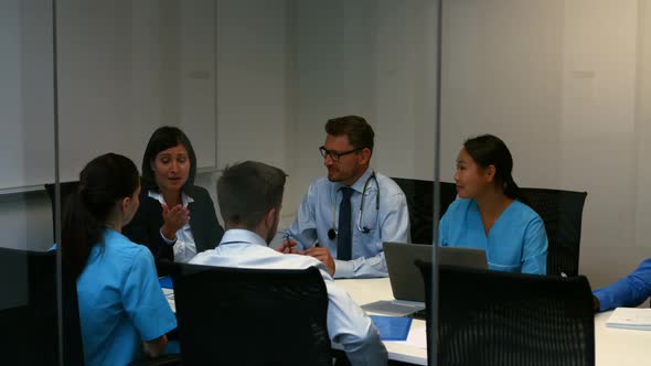 Doctor interacting with colleagues in meeting