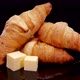 Fresh baked crusty croissants with butter. French croissants rotating on a black background.  - VideoHive Item for Sale