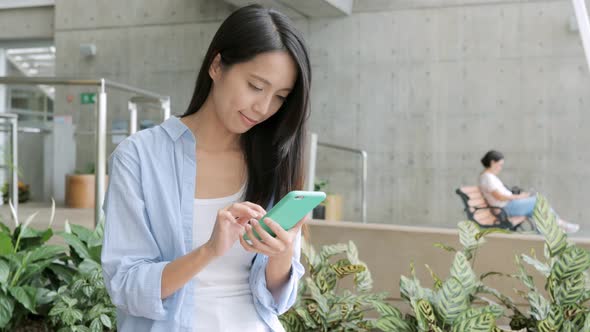 Woman Working on Mobile Phone in University