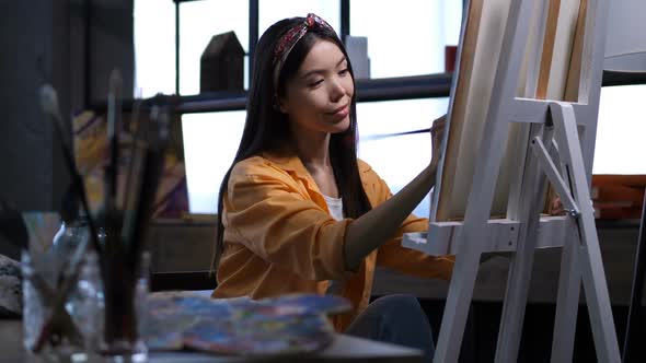 Female Artist Making a Painting at Art Studio