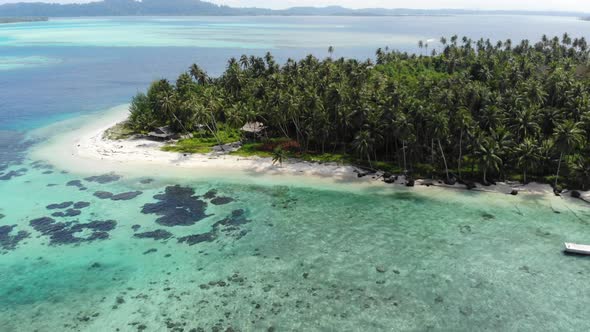 Aerial: flying over tropical island white beach caribbean sea turquoise water co