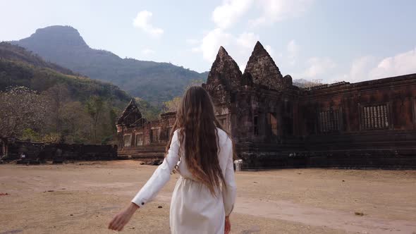 Beauty woman walk near ancient palace Vat Pou Hindu Temple Phu Kao mountain Laos, Asia, UNESCO, Slow