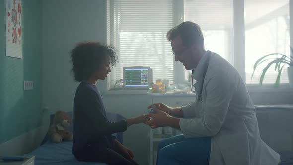 Pediatrician Using Oximeter Checking Oxygen Saturation on Girl Finger Close Up