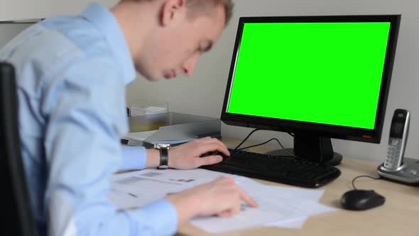 Man Works on Desktop Computer in the Office - Typing on Keyboard - Green Screen