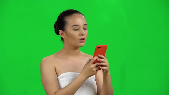 Spa Woman Sends Message on Mobile Then Makes Selfie. Green Screen