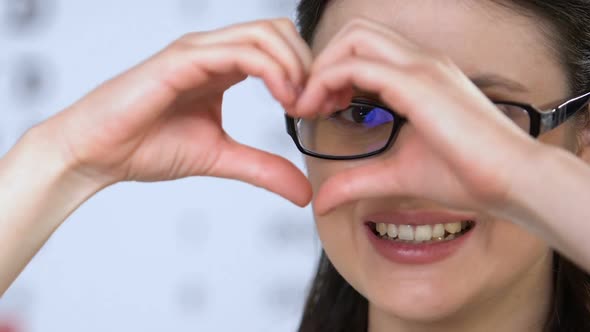 Female in Glasses Showing Heart Sign With Hands, Vision Health Care, Clinic