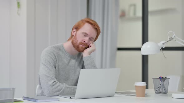 Redhead Man with Laptop Taking Nap at Work 