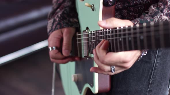 Close up of a man playing guitar