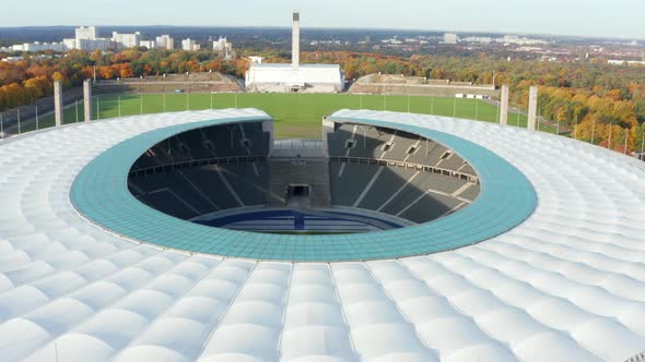 Revealing Establishing Shot of Empty Stadium Showing Green Soccer Football Field in Berlin, Germany