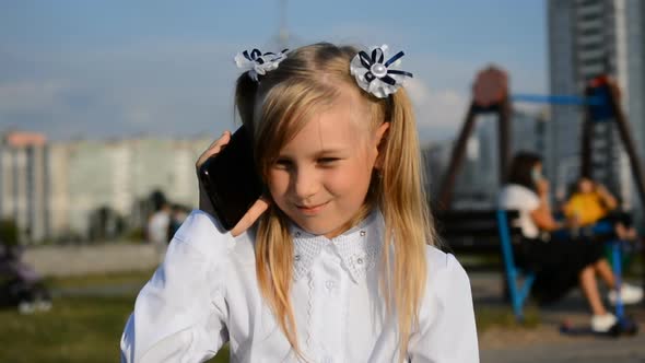 Happy Little Kid in White Dress Talking By Mobile Phone