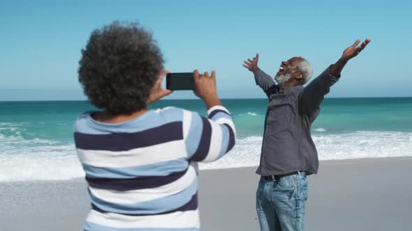 Senior woman taking old man in photo