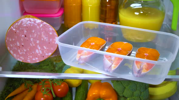 Raw Salmon Steak in the Open Refrigerator