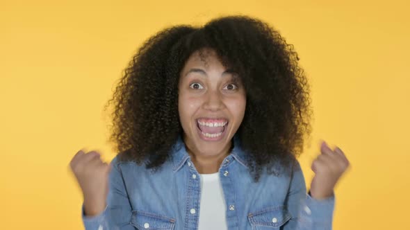 Excited African Woman Celebrating Yellow Background