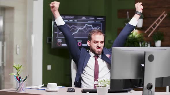 Happy and Excited Businessman in Modern Looking Office