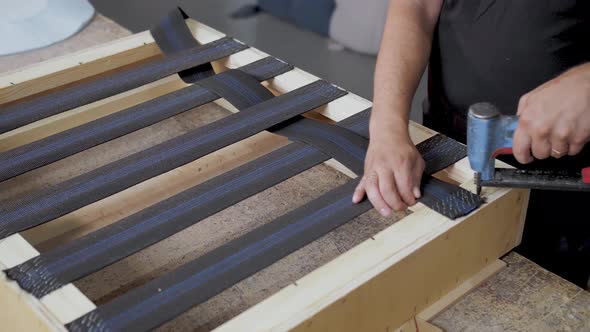 A Worker Makes a Sofa in a Furniture Factory