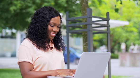 African Student Girl with Laptop in City