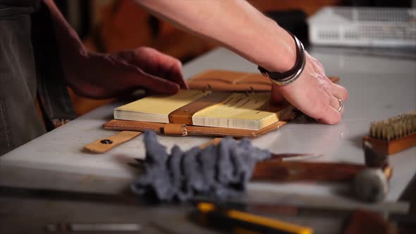 Man Puts a Set of Sheets in the Leather Cover.