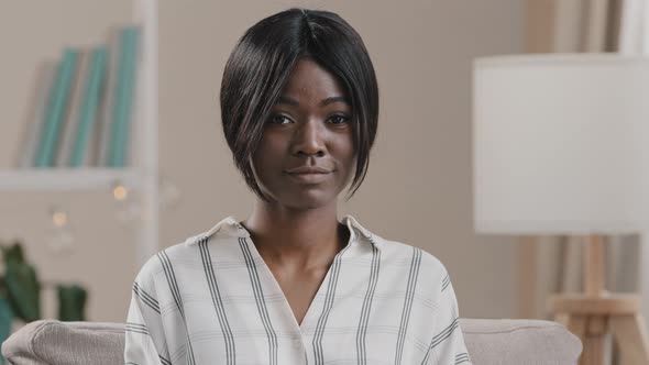 Female Portrait Positive Young Confident African American Woman Turns Looking at Camera Sitting on