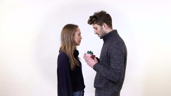 A young man offering a present to a woman