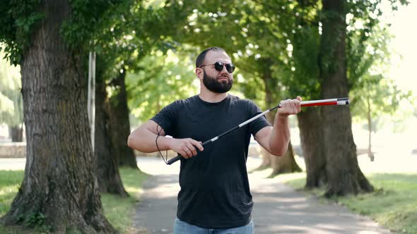 Blind Bearded Man Preparing White Cane for a Walk
