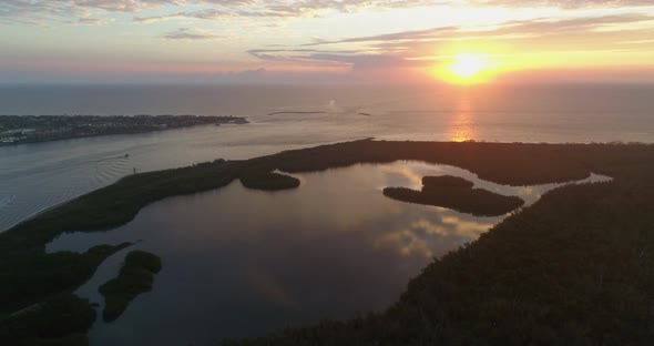 Sunset and Clouds Reflecting on Calm Water by Jupiters Island Florida