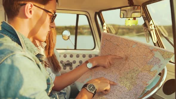 Couple Travel With Map In Car In Summer. Happy Smiling Young People Using Map,