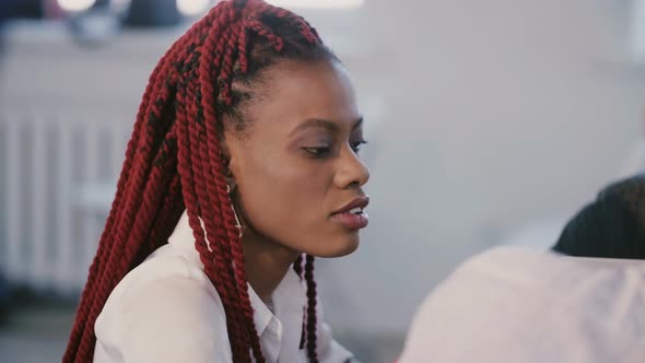 Medium Shot Portrait of Young Positive African American Office Corporate Employee Focused at Team