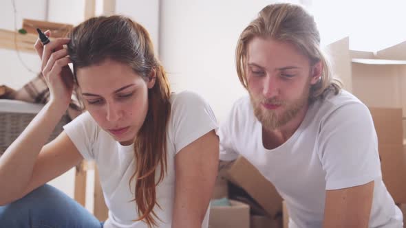 Tender Caucasian Pair Sitting on Floor in New Apartment in Slowmotion