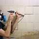 Bearded Middleaged Worker with Tools is Trying to Tear Off an Old White Dirty Tile in a Toilet - VideoHive Item for Sale