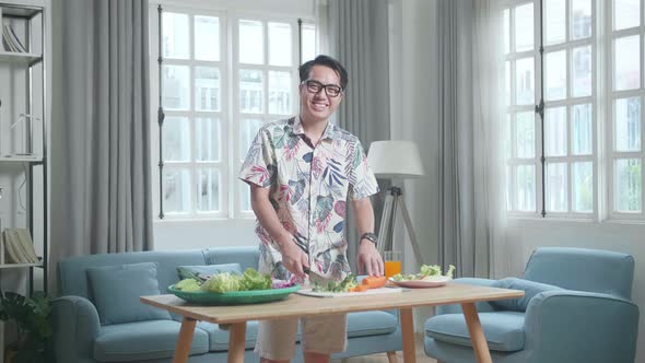 Asian Man Smiling To Camera While Cook Healthy Food At Home