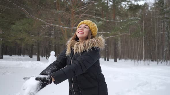 Woman Is Throwing Some Snow in the Air Enjoying the Cold Season in Slow Motion