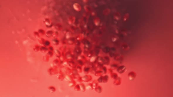 Super Slow Motion Grain is a Pomegranate with Water Droplets