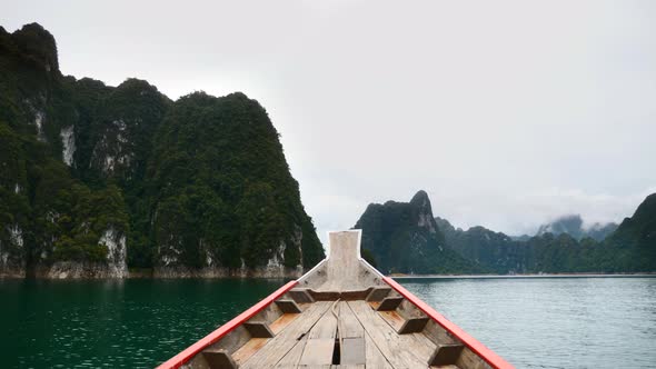 Lake Tour on Traditional Wooden Thai Longtail Boat Sailing with Limestone Cliffs