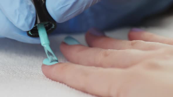 Young Woman Paints Her Nails with Natural Gel Base. Nails Manicure. 