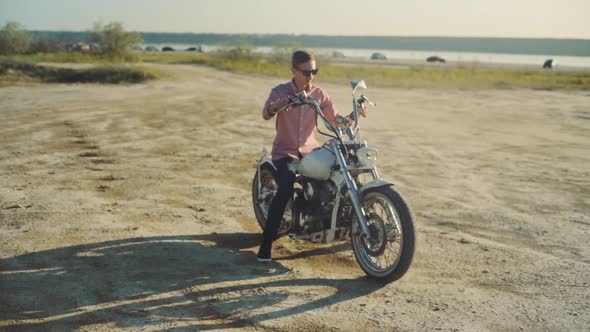 Motorcyclist Driving His Motorbike on the Dirt Road During Sunset Slow Motion