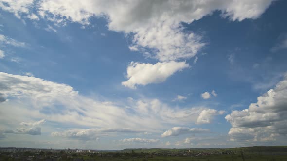 Time Lapse Footage of Fast Moving White Puffy Clouds on Blue Clear Sky Over Rural Area