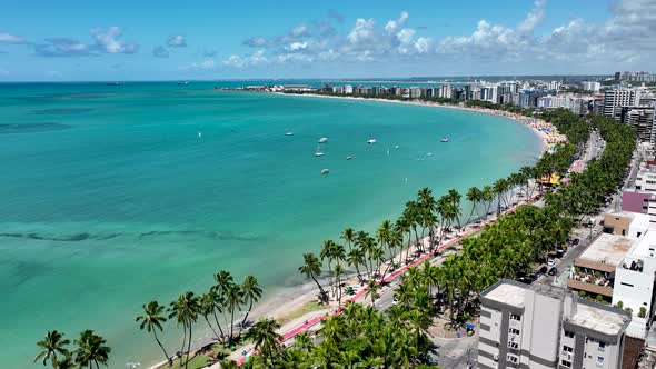 Aerial panning shot of turquoise water beach at Maceio Alagoas Brazil.