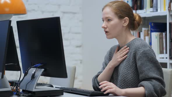 Shocked Redhead Woman, Upset while Working on Computer