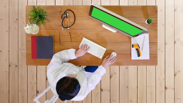 Senior Female Doctor Working on Computer