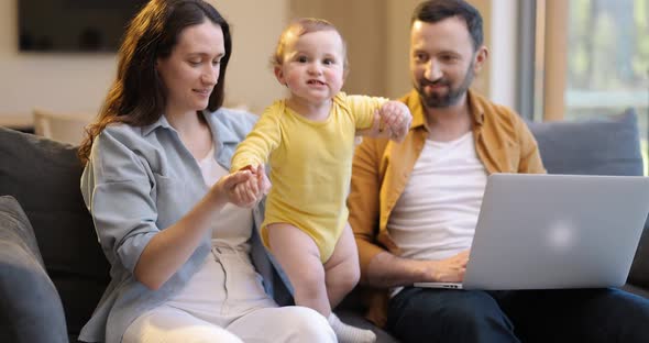 Man Works From Home with His Wife and Little Son