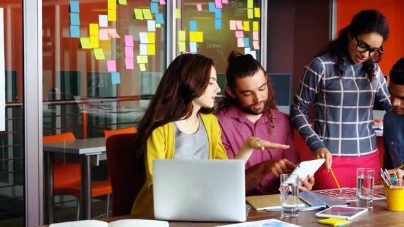 Executives interacting with each other while working