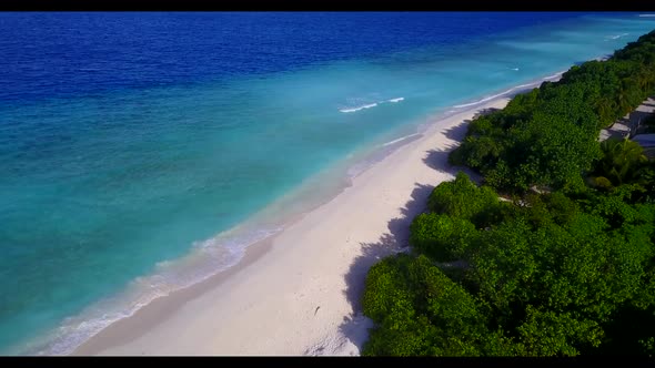 Aerial top down nature of marine tourist beach trip by blue green sea and white sandy background of 