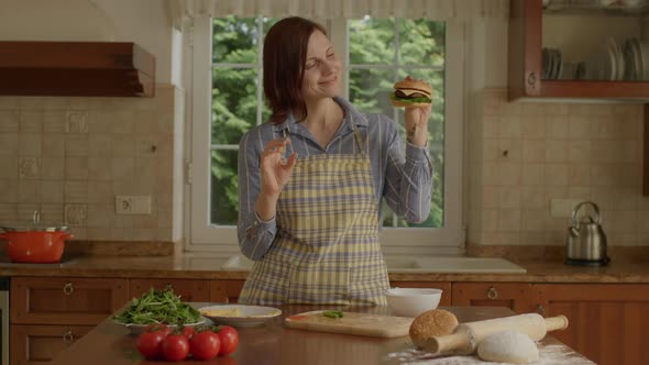 30s Female Chef Happy to Cook Burger in the Kitchen