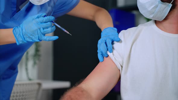 Female Health Professional is Giving Injection with Vaccine for Patient