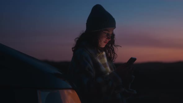 Soft Focus on Dreamy Girl Using Phone at Night