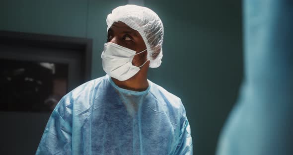 A Team of Surgeons Perform an Operation in a Bright Operating Room