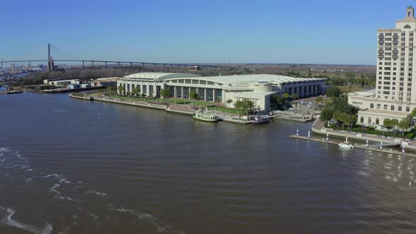 Aerial approach to Savannah River waterfront with hotel and conference center