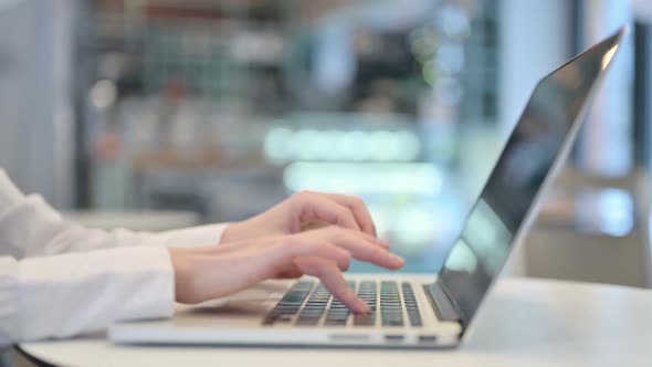 Female Hands Typing on Laptop Keyboard Close Up